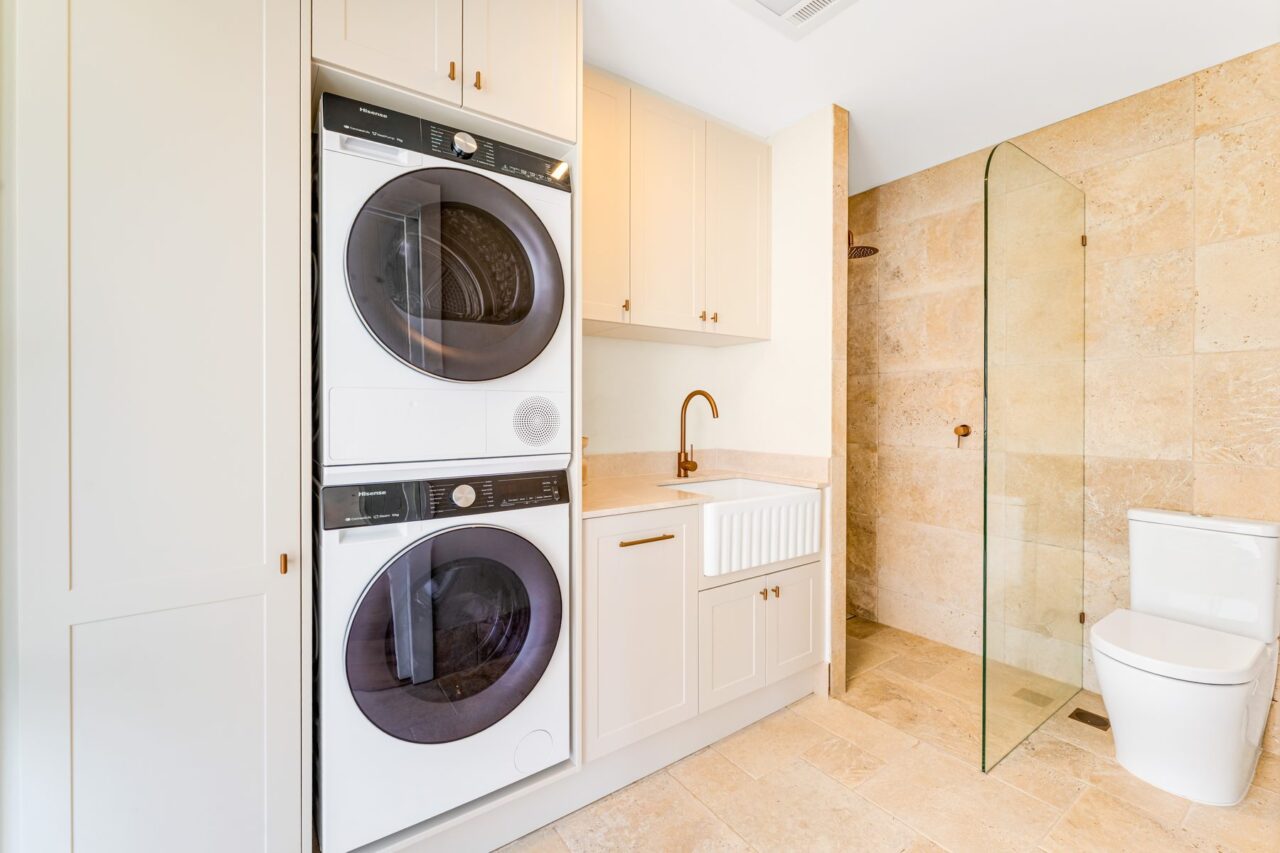 Laundry with stacked machines, butler's sink and adjoining shower, Mount Riverview