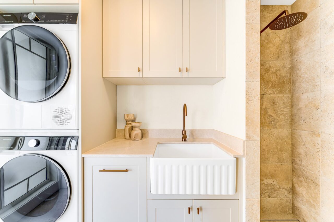 Butler's sink and stone benchtop beside the stacked washer and dryer, Mount Riverview